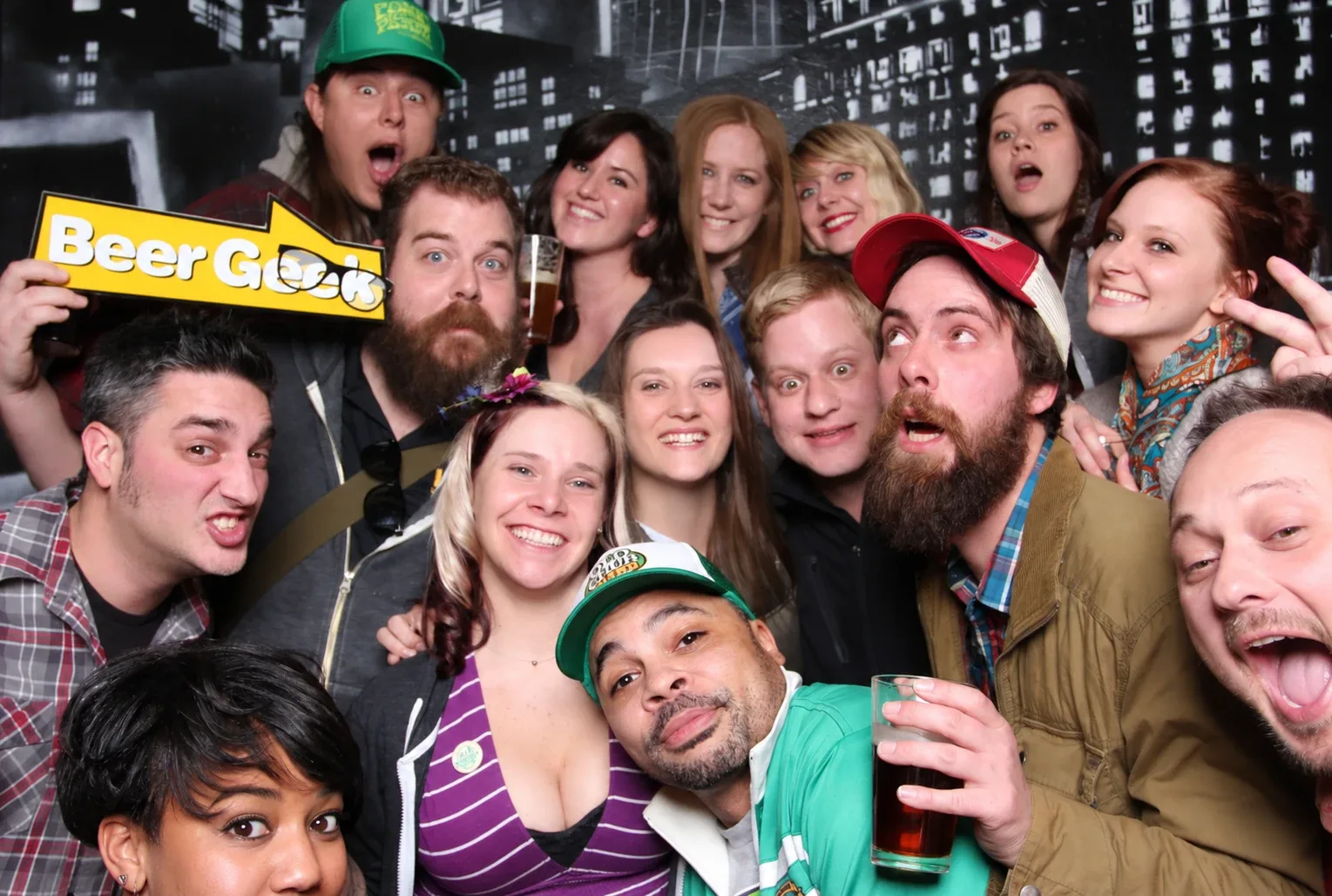 A crowd of friends celebrating together in a photo booth